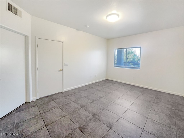 unfurnished room featuring tile patterned floors