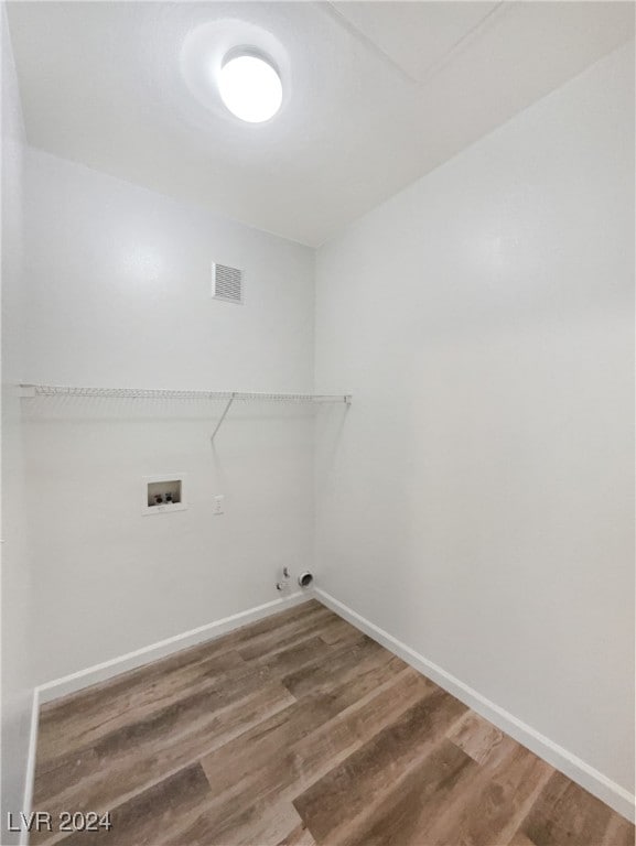 washroom featuring washer hookup, hardwood / wood-style flooring, and hookup for a gas dryer