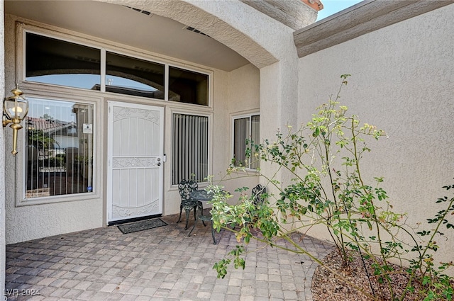 entrance to property featuring a patio