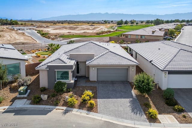 view of front of home featuring a garage and a mountain view