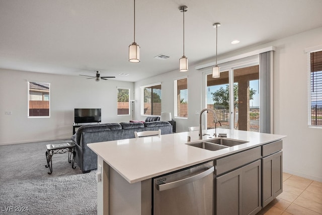 kitchen featuring pendant lighting, dishwasher, a kitchen island with sink, sink, and ceiling fan