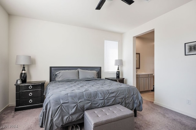 bedroom featuring light colored carpet, connected bathroom, and ceiling fan