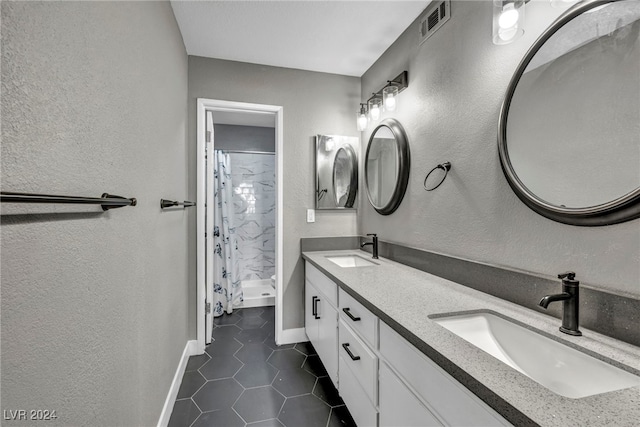 bathroom with curtained shower, tile patterned floors, and vanity