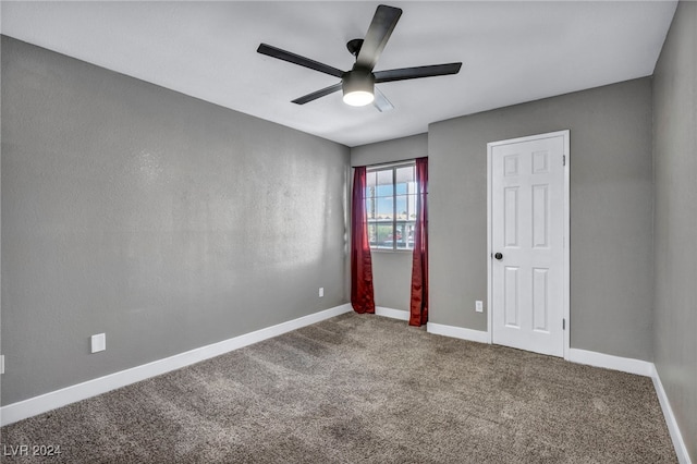 empty room with carpet flooring and ceiling fan