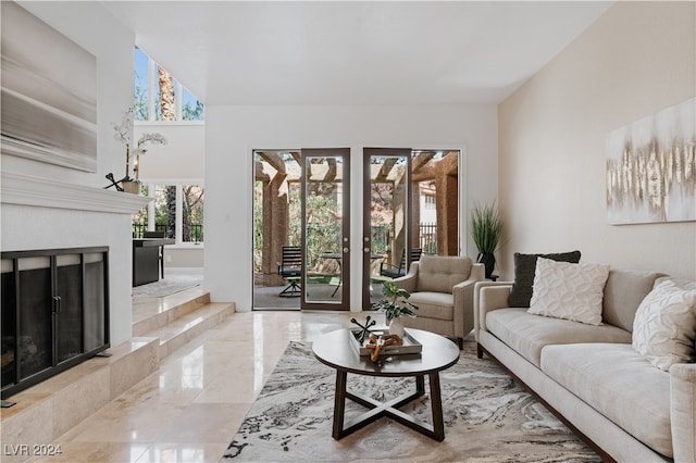 living room with french doors and a tile fireplace