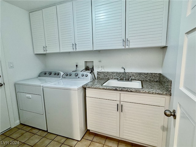 laundry area featuring cabinets, washer and dryer, sink, and light tile patterned floors