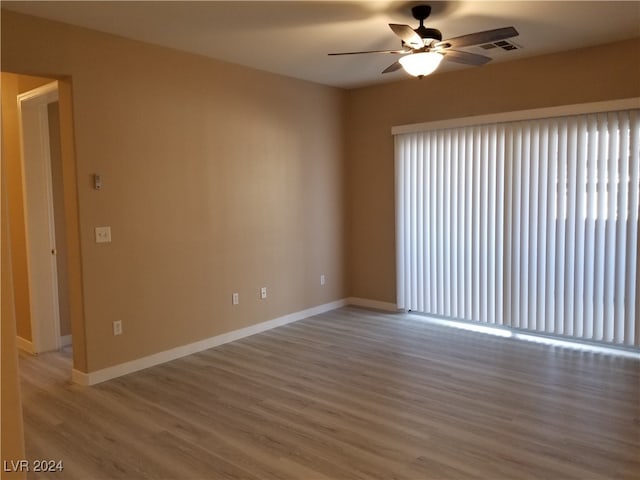 unfurnished room with ceiling fan and hardwood / wood-style flooring