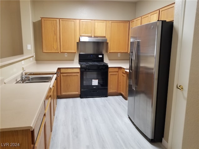 kitchen with stainless steel refrigerator with ice dispenser, black gas stove, light brown cabinetry, light hardwood / wood-style floors, and sink