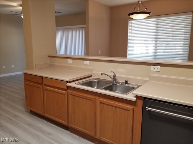 kitchen with dishwashing machine, light hardwood / wood-style floors, ceiling fan, sink, and pendant lighting