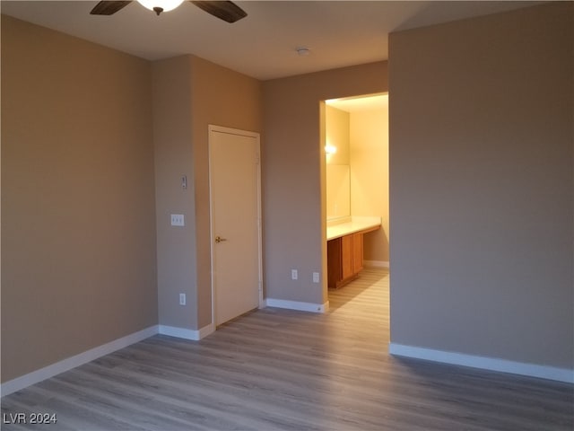 empty room featuring ceiling fan and light hardwood / wood-style floors