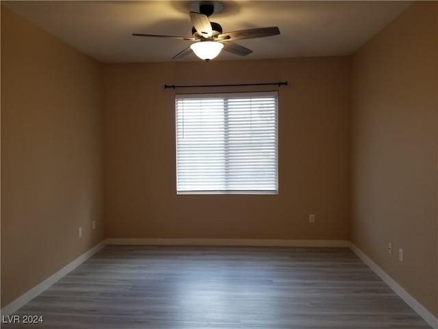 spare room with ceiling fan and hardwood / wood-style flooring