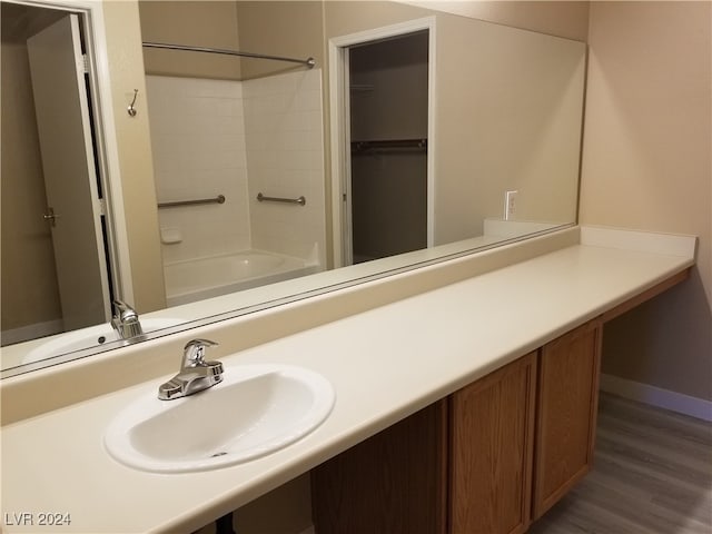 bathroom with vanity, shower / washtub combination, and wood-type flooring