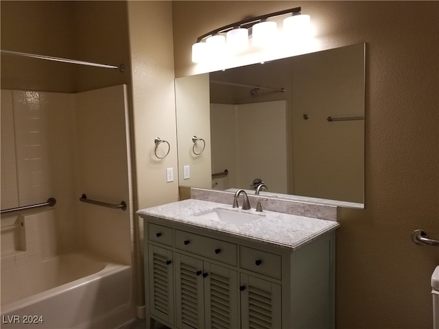 bathroom featuring  shower combination and vanity