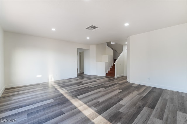 unfurnished living room with dark wood-type flooring