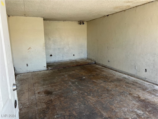 unfurnished room featuring a textured ceiling