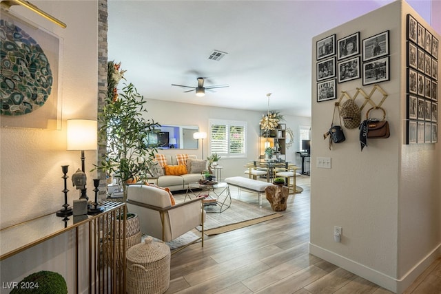 living room with ceiling fan and hardwood / wood-style floors