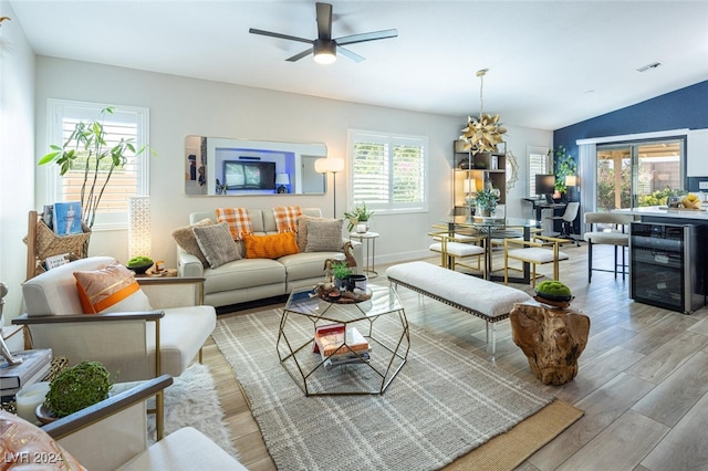 living room with lofted ceiling, ceiling fan, light hardwood / wood-style floors, and wine cooler