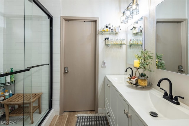 bathroom featuring vanity, hardwood / wood-style floors, and an enclosed shower