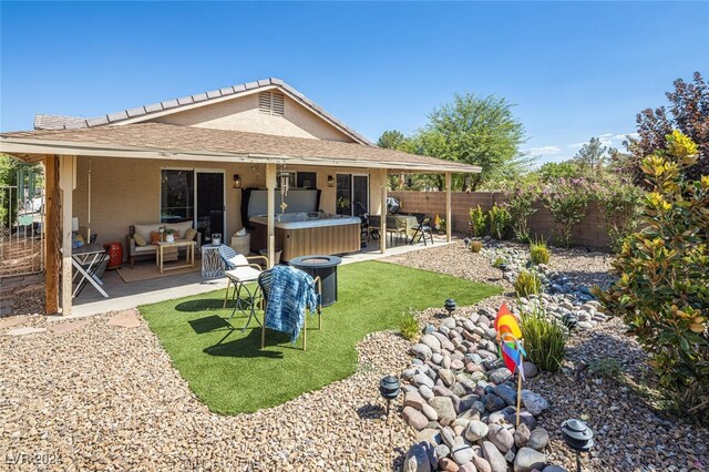 back of property featuring a patio area and outdoor lounge area