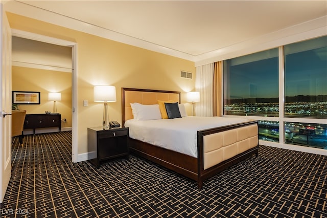 bedroom with dark colored carpet