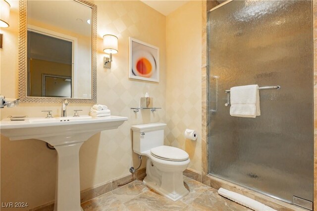 bathroom with a shower with shower door and toilet