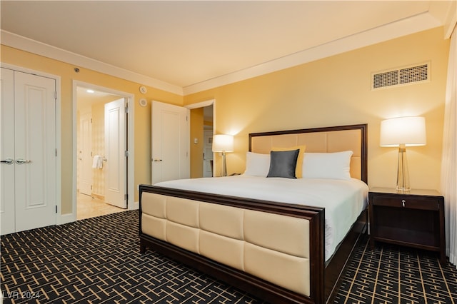 carpeted bedroom with ornamental molding