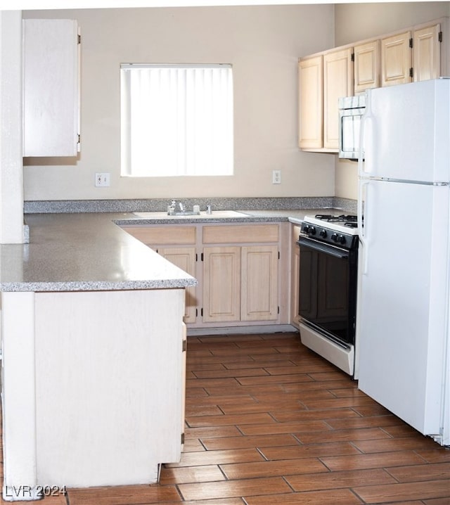 kitchen with white appliances, dark hardwood / wood-style floors, and sink