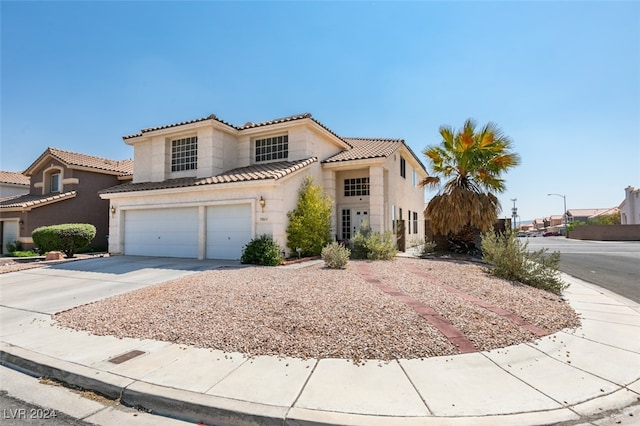 mediterranean / spanish-style home featuring a garage