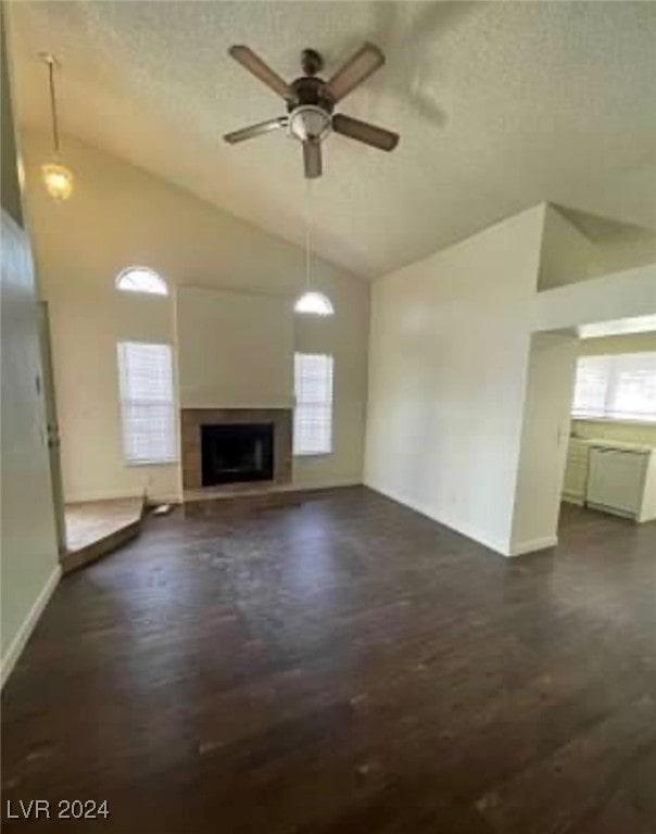 unfurnished living room with high vaulted ceiling, a wealth of natural light, and ceiling fan