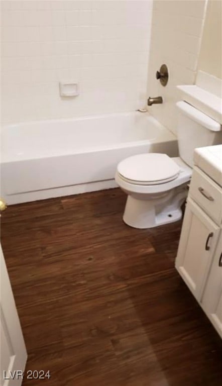 full bathroom featuring wood-type flooring, toilet, shower / bath combination, and vanity