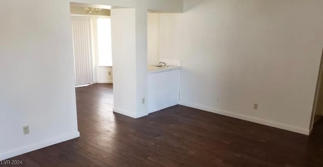 unfurnished room with dark hardwood / wood-style floors