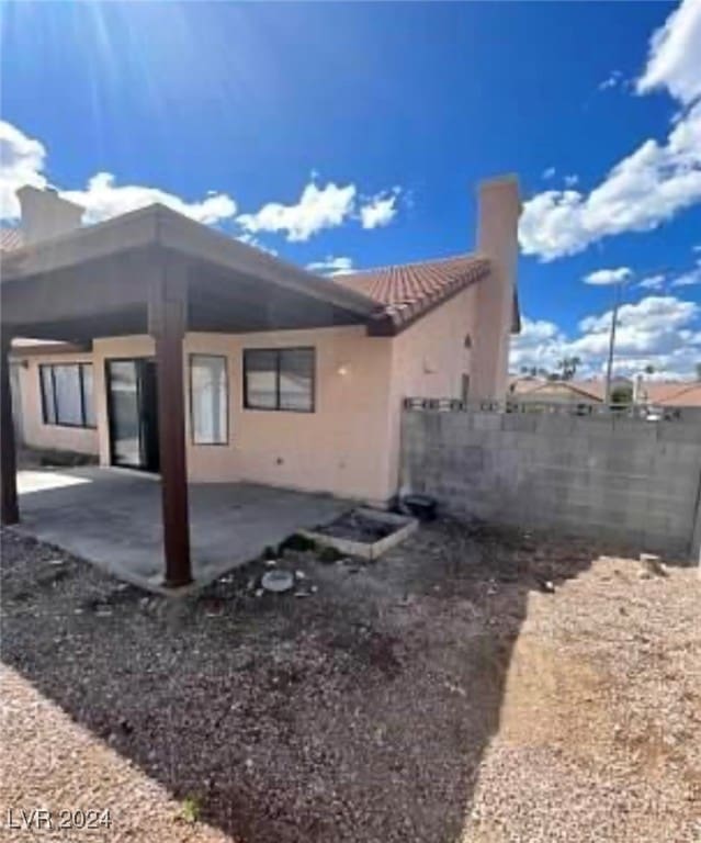 rear view of property featuring a patio area