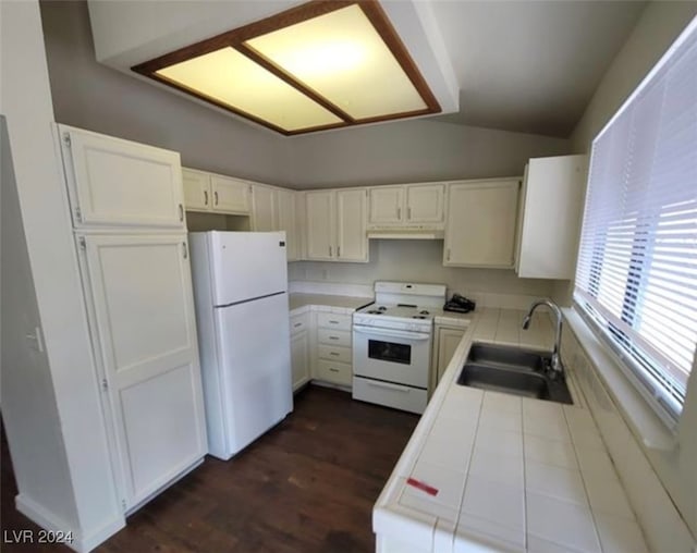 kitchen featuring tile countertops, white appliances, sink, lofted ceiling, and dark hardwood / wood-style floors