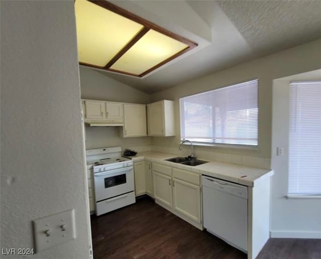 kitchen featuring vaulted ceiling, dark hardwood / wood-style floors, white appliances, sink, and white cabinets