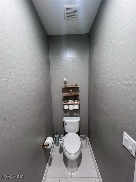 bathroom featuring toilet and tile patterned floors