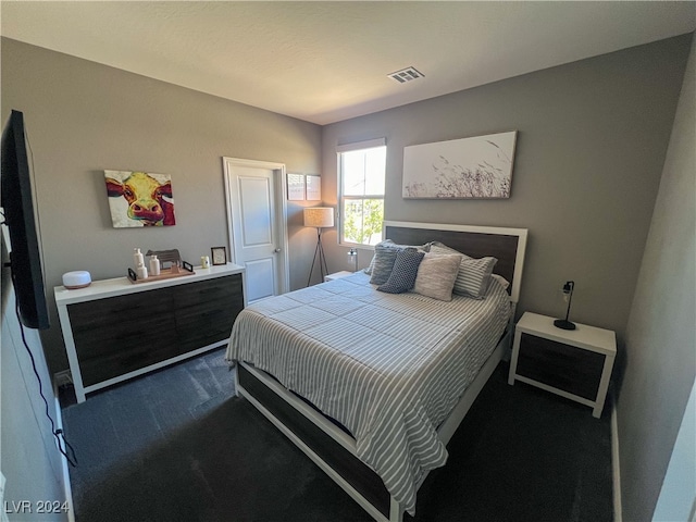 bedroom featuring dark colored carpet