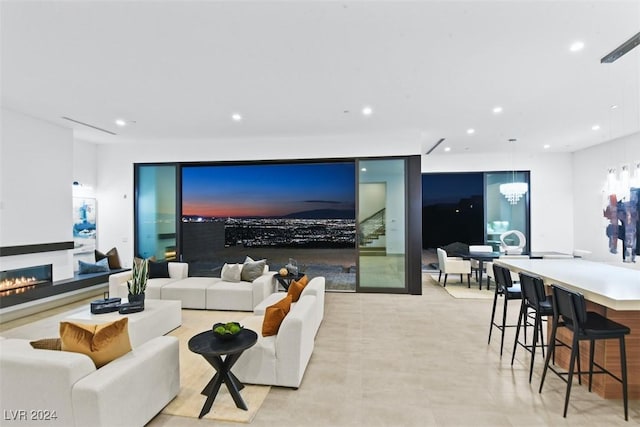 living area with recessed lighting and a warm lit fireplace