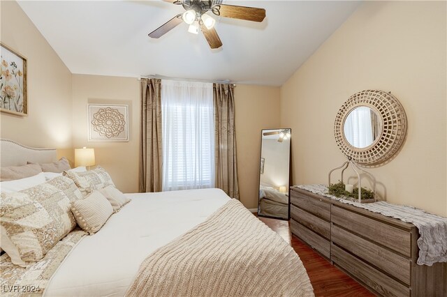 bedroom with lofted ceiling, ceiling fan, and hardwood / wood-style floors