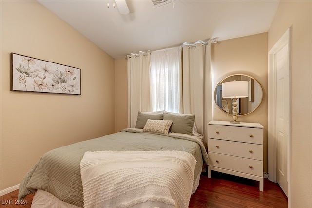 bedroom featuring dark wood-type flooring, ceiling fan, and vaulted ceiling