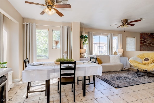 tiled dining area featuring plenty of natural light and ceiling fan