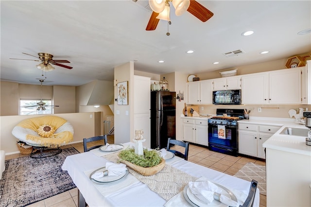 kitchen with black appliances, ceiling fan, white cabinetry, and light tile patterned flooring