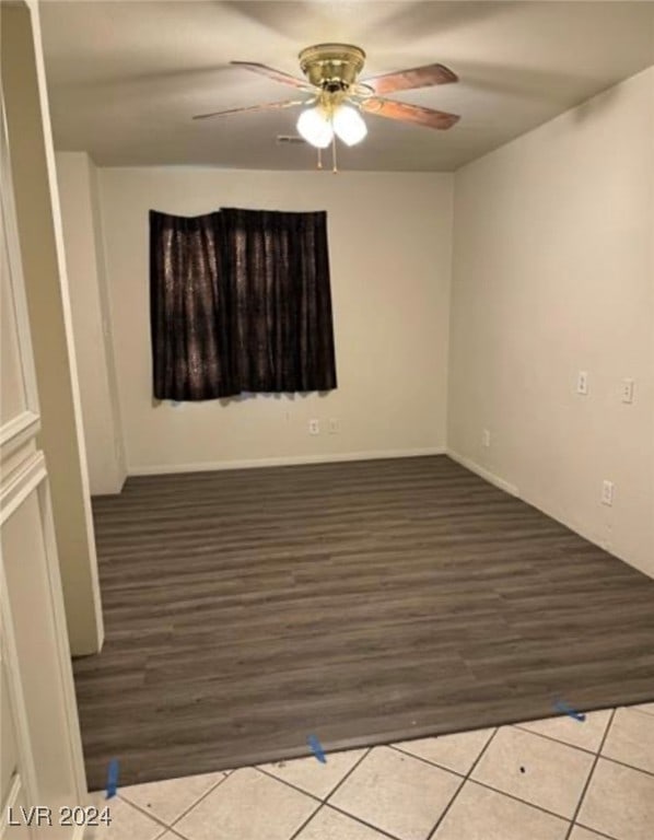 empty room featuring light wood-type flooring and ceiling fan