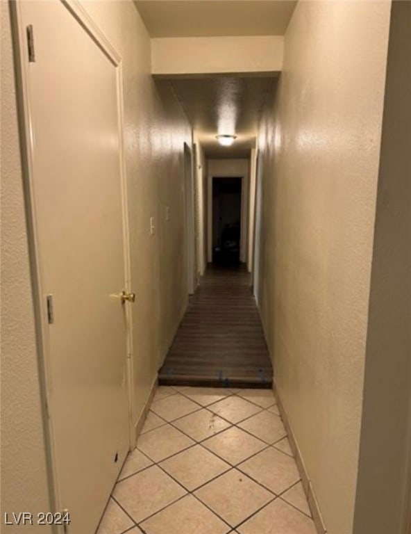 corridor featuring light tile patterned floors