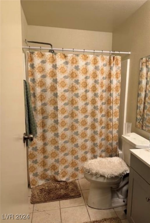 bathroom with vanity, toilet, a shower with curtain, and tile patterned flooring