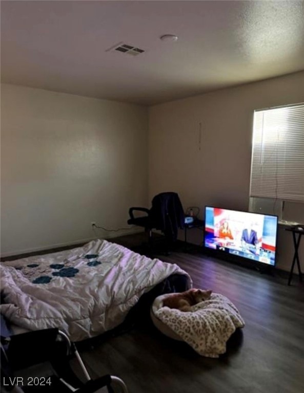 bedroom with hardwood / wood-style floors