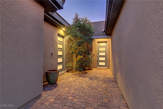 view of exterior entry at dusk