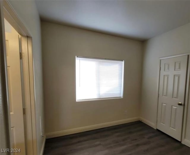 unfurnished bedroom with dark hardwood / wood-style floors