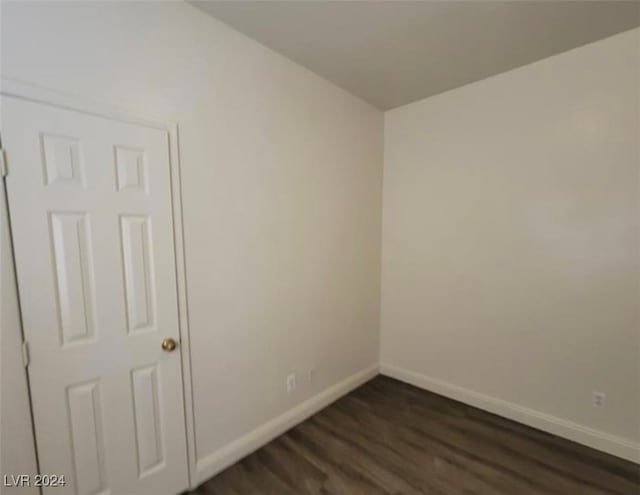 spare room with dark hardwood / wood-style floors