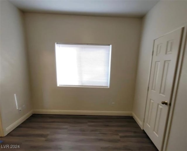 empty room featuring dark hardwood / wood-style flooring