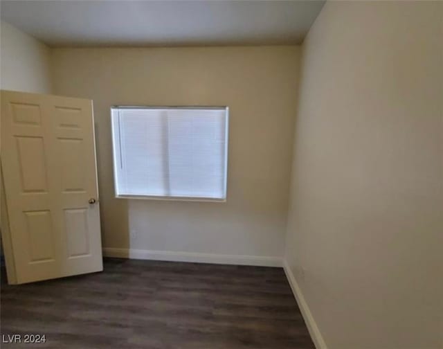 unfurnished bedroom with dark hardwood / wood-style floors